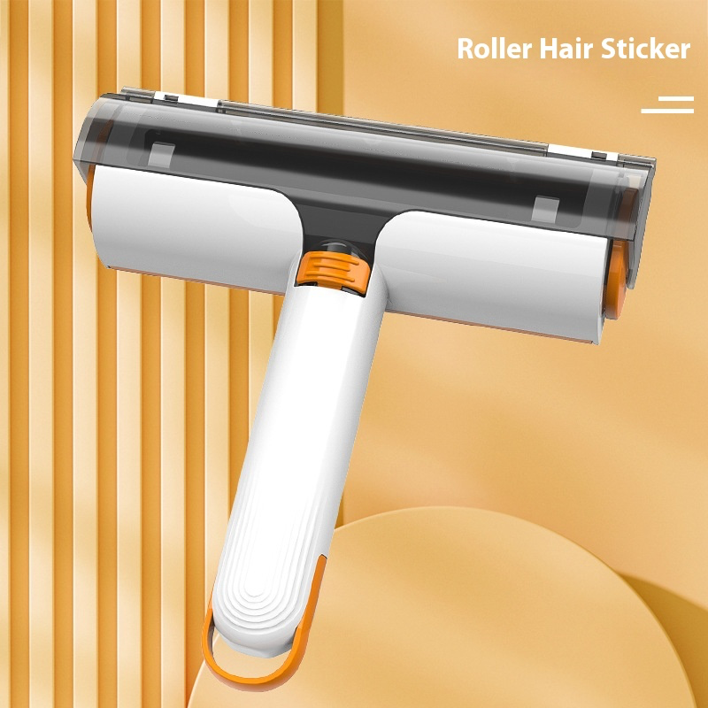 White and orange manual pet-hair roller with collection compartment, shown on a yellow background. One roller included.